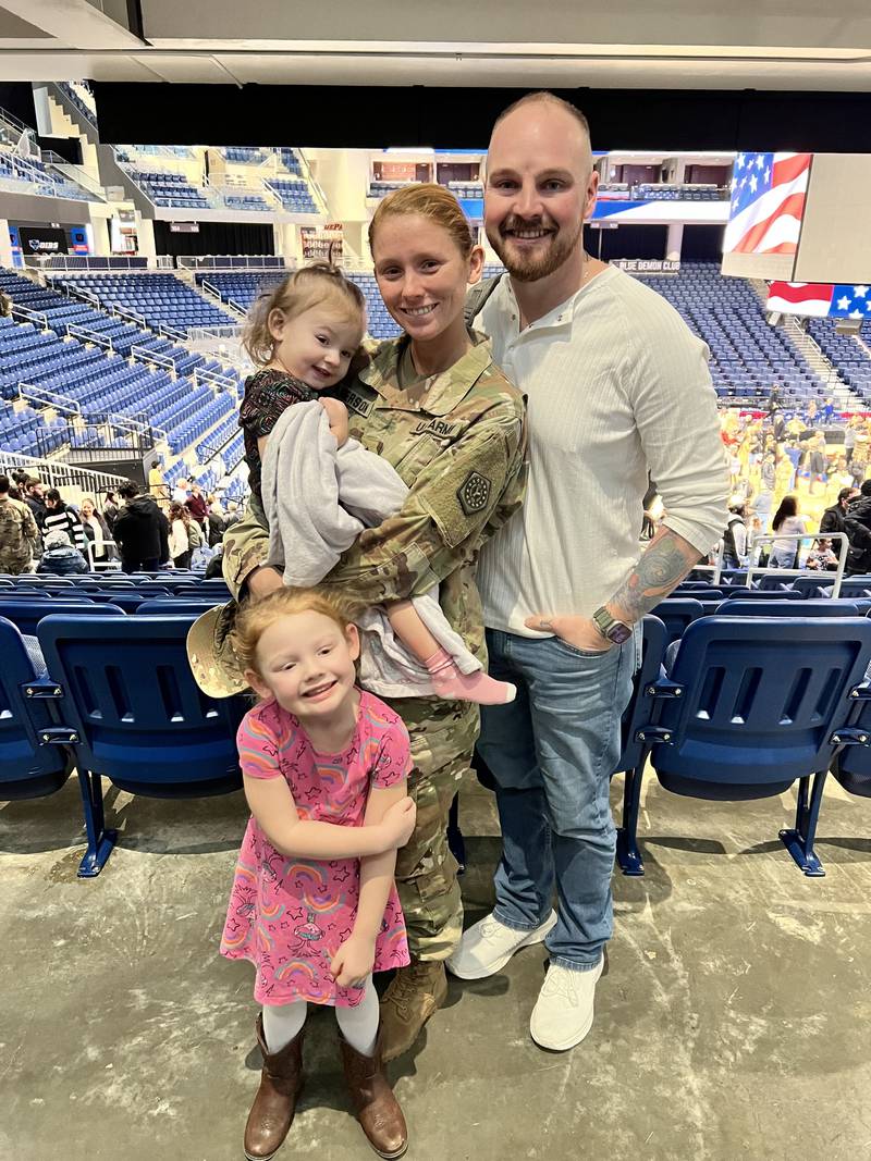 Holding her daughter Sawyer, Illinois Army National Guard Staff Sgt. Brooke Anderson is pictured with husband Matt Anderson and daughter Tayah.