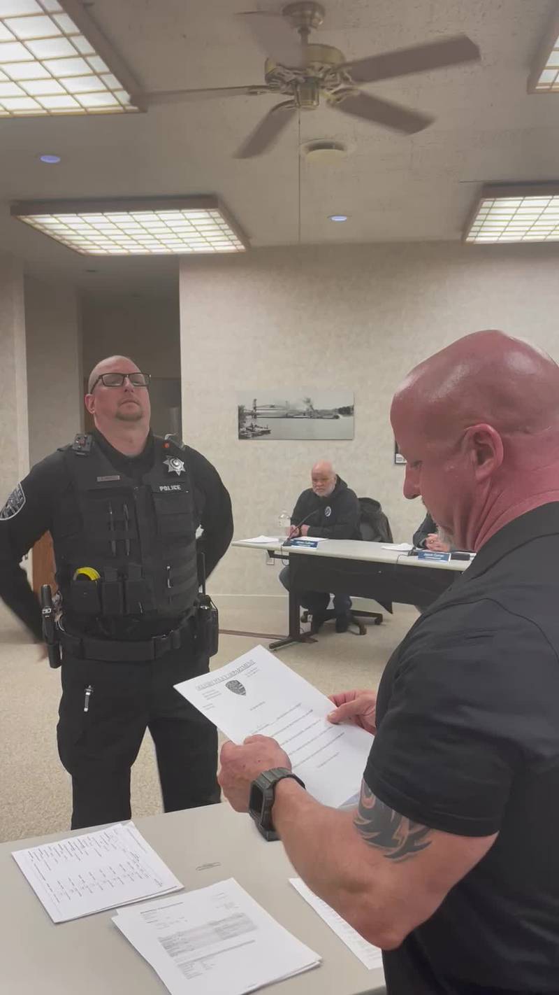 Oglesby Police Officer Scott Nuftul (left) takes the oath of office from Commissioner Terry Eutis, bringing the department to full staff.
