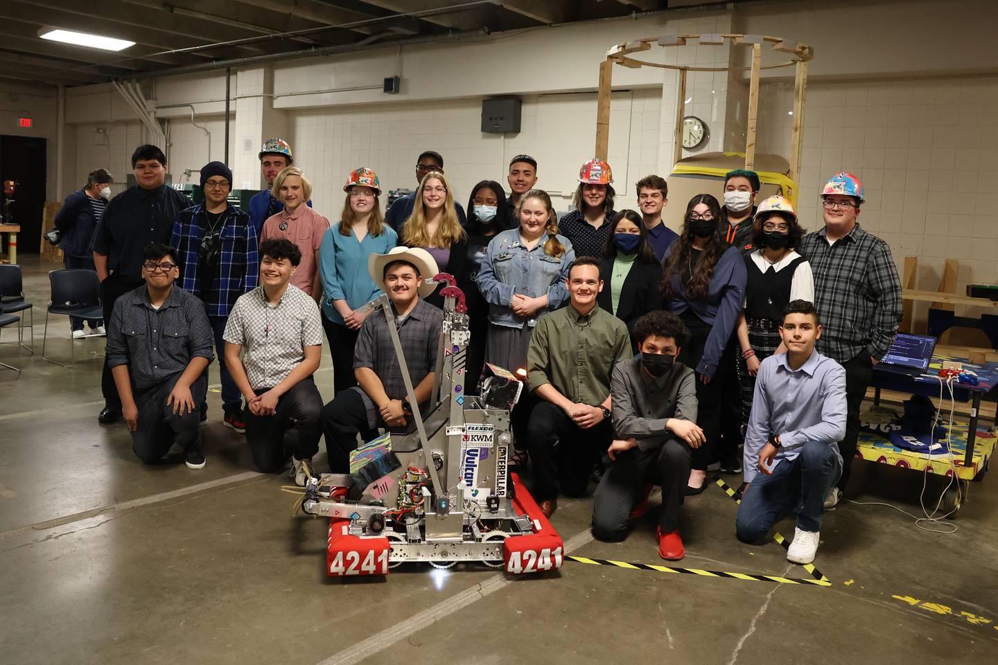 Steel Tigers Robotics Team 4241 pose with their robot at the unveiling for their upcoming FIRST Robotics Midwest Regional Competition. Wednesday, April 6, 2022, in Joliet.