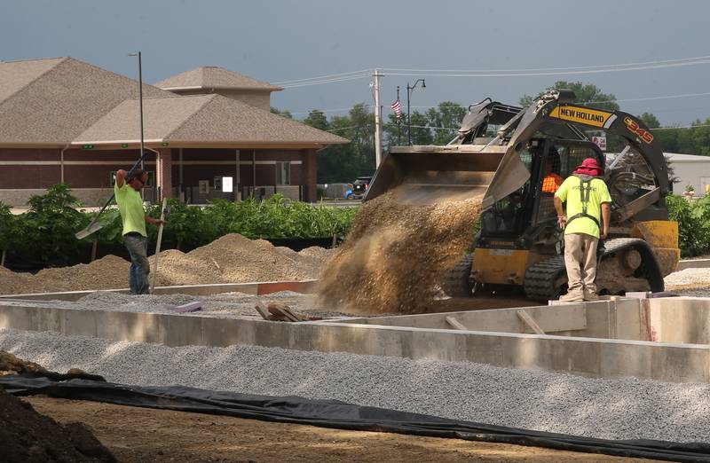 Crews move dirt near the intersection of Backbone Road and North Main Street on Tuesday, July 8, 2025 in Princeton. The foundation of a future Aldi store can be seen in the distance. Work started on the property beginning in April this year.