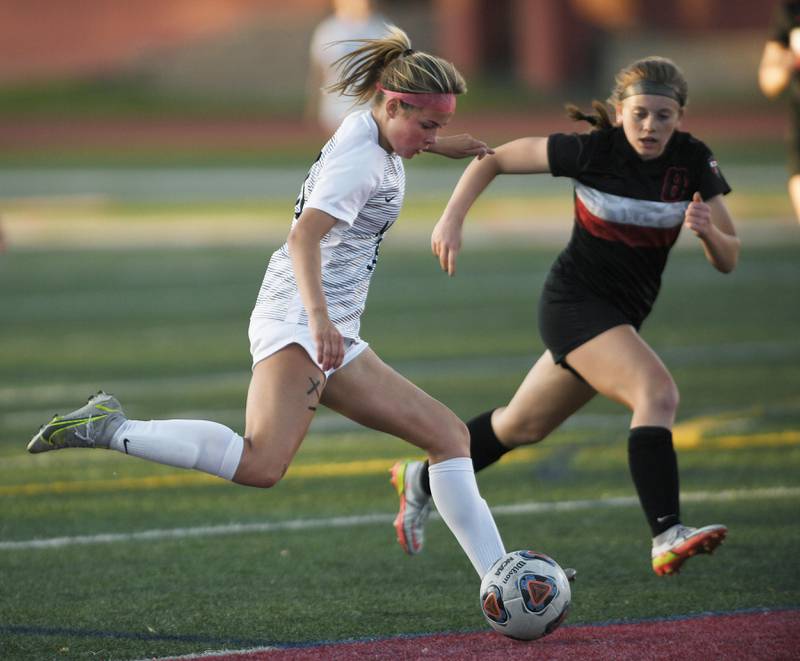 Metea Valley’s Lucy Burk takes a shot against Lincoln-Way Central’s Reagan Schultz in the Class 3A IHSA state girls soccer semifinal game in Naperville on Friday, June 3, 2022.