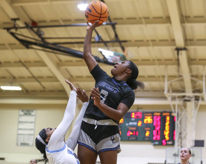 Oswego East's Avaya Kittling-Turner (3) puts up a shot over the defense of Downers Grove South's Jakylah Thomas (3) during their York Thanksgiving Tournament matchup between Oswego East at Downers Grove South Friday, Nov 20, 2025 in Elmhurst.