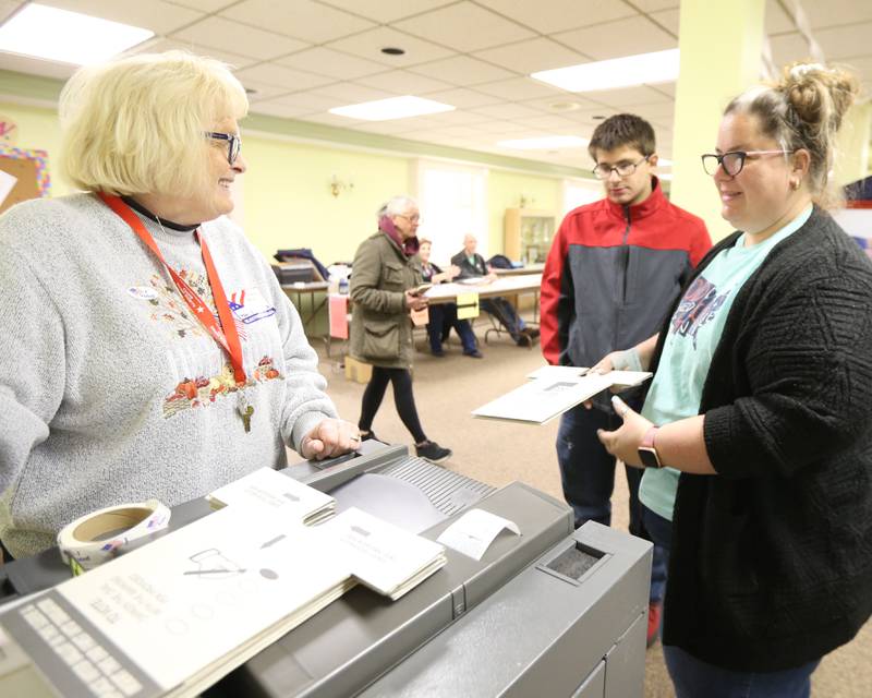 Michelle Pappas casts her ballot while her son Christopher 17, watches on Tuesday, Nov. 8, 2022 at Zion United Church of Christ in Peru.