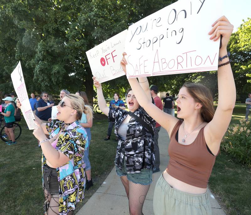 Kendal Graham, (left) 18, from Somonauk, Oli Oczkowski, 18, from Sycamore, and Alaina Bowman, (right) 16, from Sycamore, cheer as passing cars honk in support Friday, June 24, 2022, during a rally for abortion rights in front of the DeKalb County Courthouse in Sycamore. The group was protesting Friday's decision by the Supreme Court to overturn Roe v. Wade, ending constitutional protections for abortion.