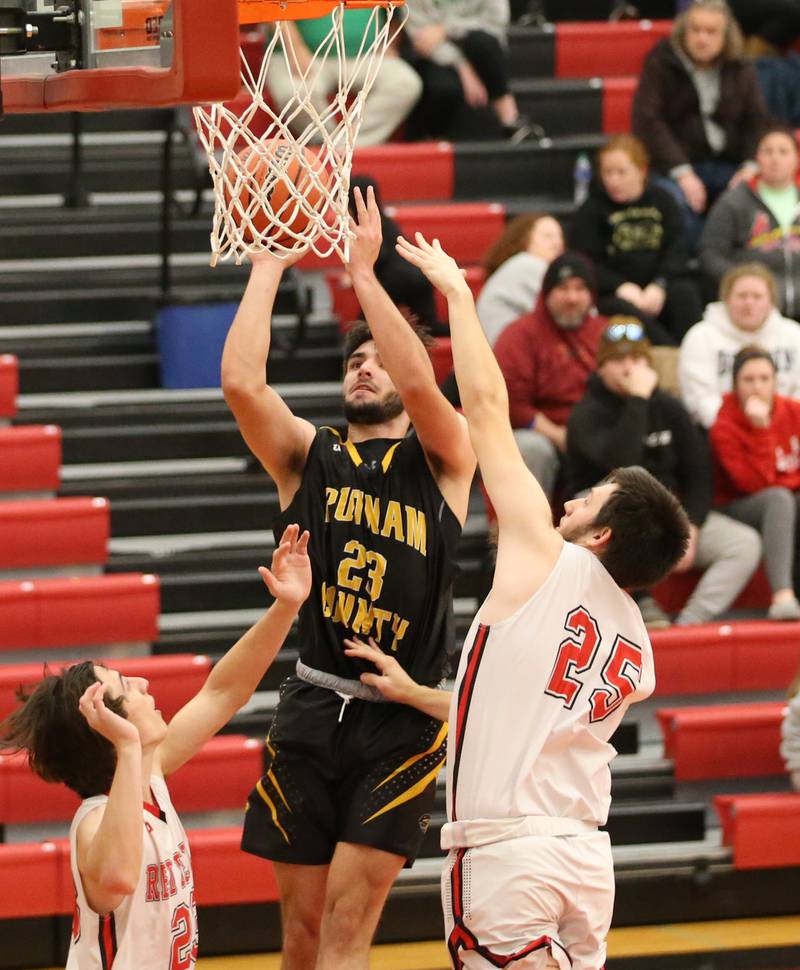 Putnam County's Jackson McDonald (23) runs toward the hoop to score a basket over Hall's Braden Curran (23) and Domonic Galetti (25) during the Colmone Classic on Tuesday, Dec. 6, 2022 at Hall Hight School in Spring Valley.