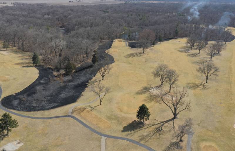 Crews burn off part of the green area for a controlled burn on Monday, March 2, 2026 at Deer Park Golf Club in Oglesby.