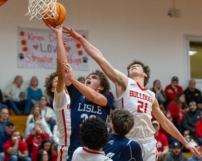 Lisle's Noah Nigro (33) lays up ball as Brennen Stillwell (21) of Streator attempts to block shot on Wednesday, Feb. 18, 2026 at Streator High School in Streator.