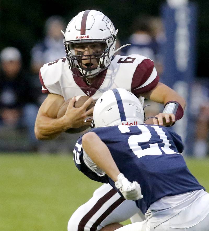 Prairie Ridge's Luke Vanderwiel tries to run around the pursuit of Cary-Grove's Tanner Hurley during a Fox Valley Conference football game on Friday, Aug. 29, 2025, at Cary-Grove High School in Cary.