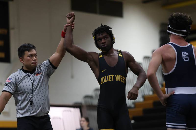 Joliet West’s Israel Booth defeats Plainfield South’s Julian Rosales in the 157 pound match on Wednesday, Dec. 3, 2025 in Joliet.