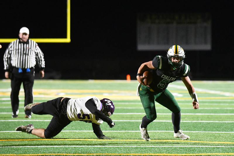 Coal City’s Zander Meents looks to the end zone after throwing off a Manteno defender Friday during this season’s game in Coal City.