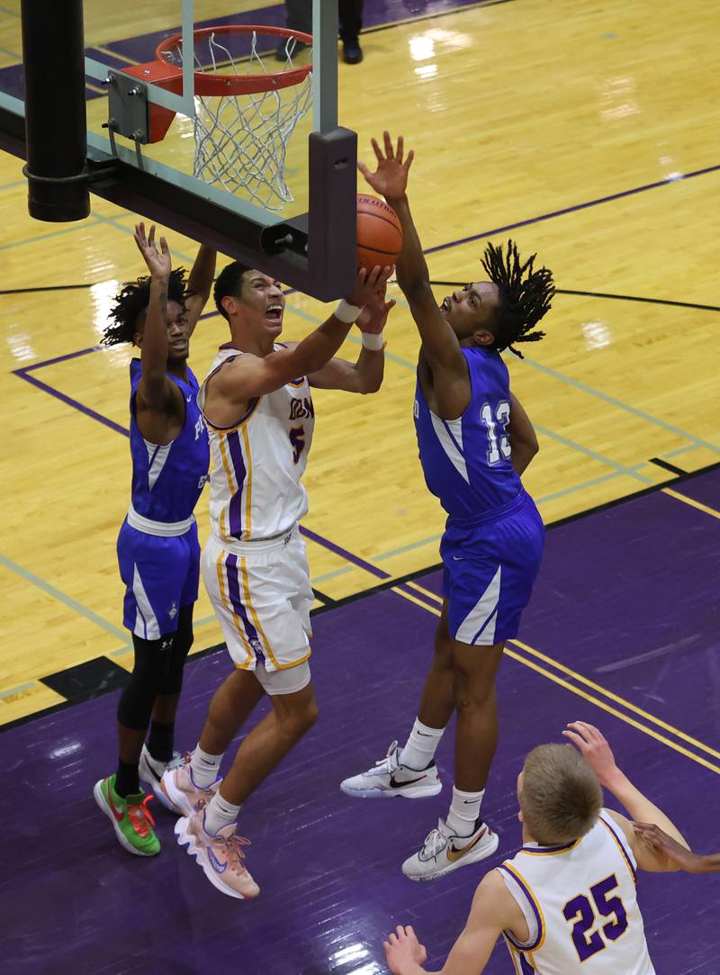 DGN's Jacob Bozeman (5) has his shot blocked by Proviso East's Damar Jenkins (12) during the boys 4A varsity regional final between Downers Grove North and Proviso East in Downers Groves on Friday, Feb. 24, 2023.
