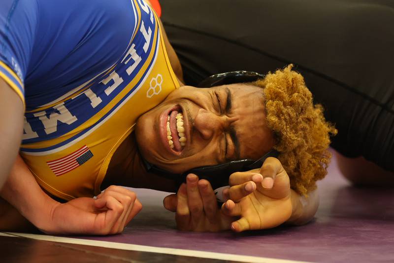 Joliet Central’s Camron Davis-Jones grimaces in pain as he gets twisted by Bradley-Bourbonnais’ Tyler Starr in the 145lb 3rd place match at the Class 3A Joliet West Regionals. Saturday, Feb. 5, 2022, in Joliet.