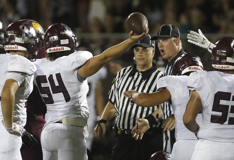 Marengo's Hunter Smith holds up a received fumble during a Kishwaukee River Conference football game Friday, Sept. 9, 2022, between Richmond-Burton and Marengo at Richmond-Burton Community High School.