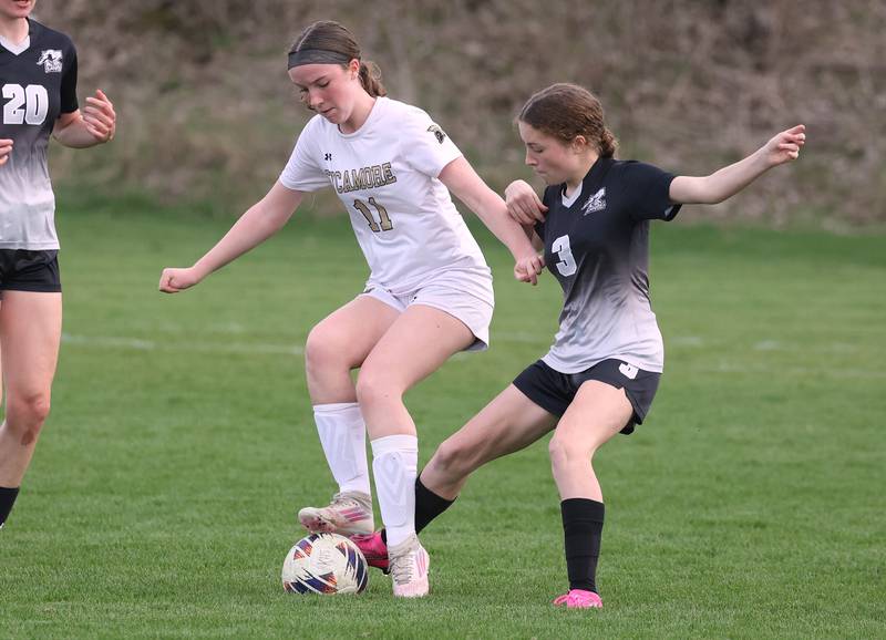 Sycamore's Ellie Lawless and Kaneland's Arden Stoddard try to win possession Monday, April 13, 2026, during their game at Kaneland High School.