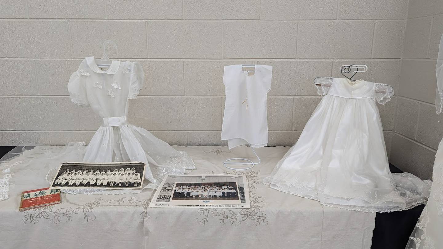 Ron and Ginna Jones provided Ginna, a founding family of St. Paul the Apostle Catholic Church in Joliet, provided Ginna Jones’ baptismal gown, along with a first communion dress, photographs and a children’s prayer book, for Sunday's celebration. These are seen on Wednesday, June 19, 2024, at St. Paul the Apostle Catholic Church in Joliet.