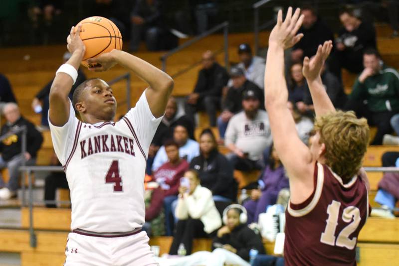 Kankakee's Myair Thompson, left, shoots as Morris' Caden Medler defends during the IHSA Class 3A Geneseo Regional semifinals Wednesday, Feb. 25, 2026.