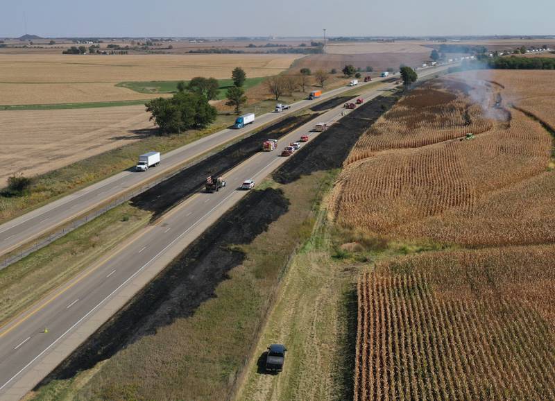 Firefighters extinguish a brushfire on Wednesday, Oct. 9, 2024 along Interstate 80 in the eastbound lane near mile post 65 in Bureau County.  A MABAS box alarm was sent out around 11:45 a.m. and upgraded to a fourth-alarm. Interstate 80 was shut down in the Eastbound lane while firefighters doused the flames. Fire companies from Utica, Oglesby, Ladd, Bureau, Hennepin, Peru, La Salle, Spring Valley and others responded to the scene.