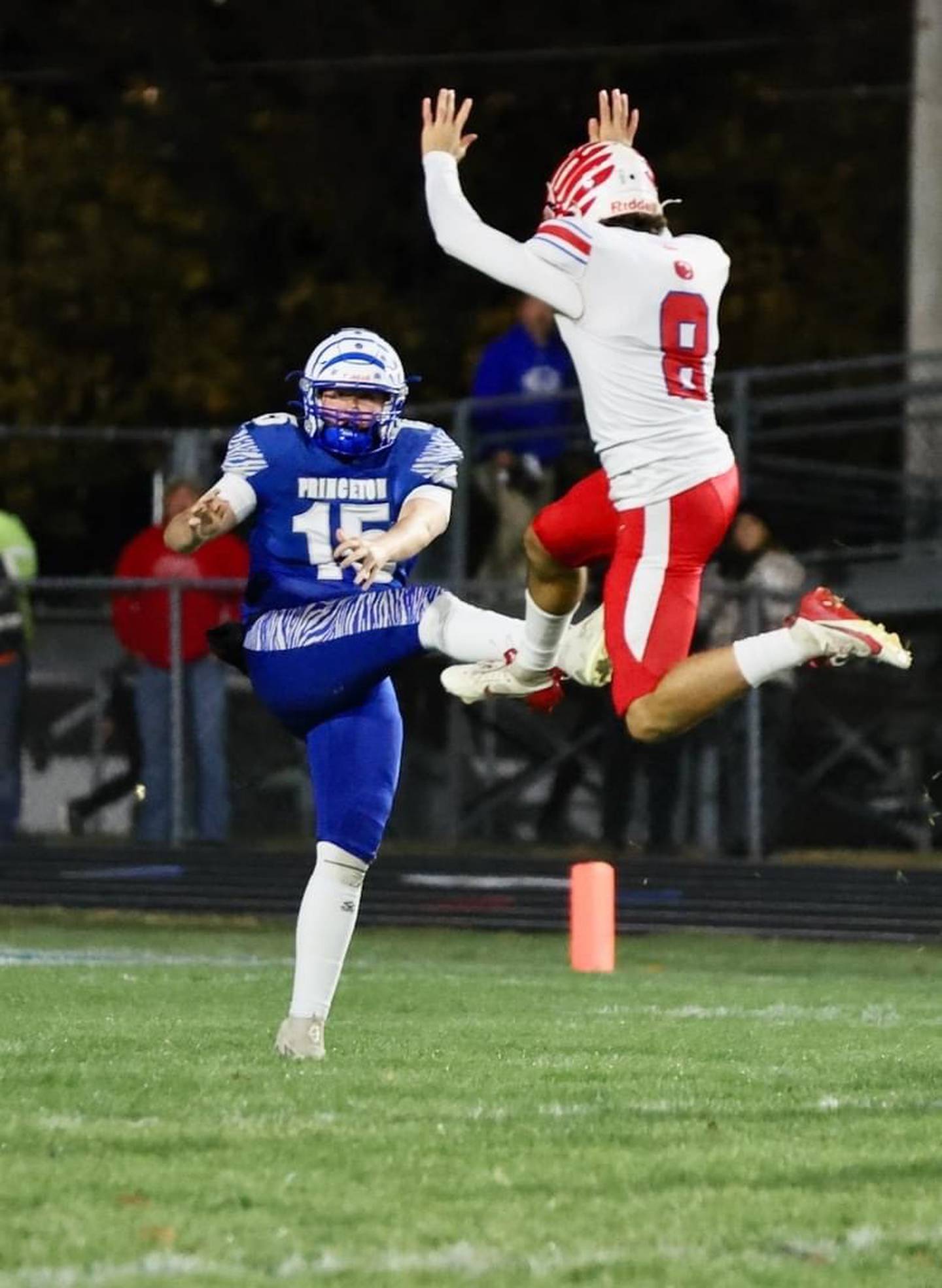 Princeton senior Jordan Reinhardt gets a punt off Friday night despite the presence of Oregon's Jakobi Donegan at Bryant Field. He averaged 40.3 yards on three punts with a long of 45 yards, pinning the Hawks at their own 9 in the second quarter.
