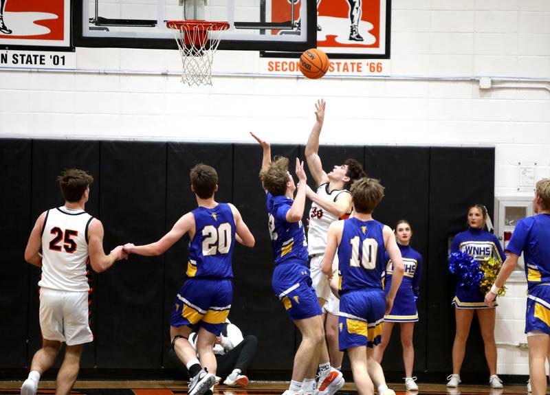 Wheaton Warrenville South's Luca Carbonaro (center) gets a shot during a game against Wheaton North on Friday, Feb. 7, 2025 in Wheaton.