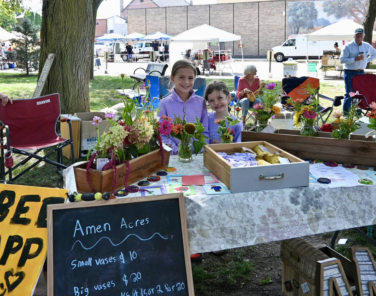 Nora and Myla Maierhofer, of Seneca, stand in front of their business Amen Acres during Saturdays fair.