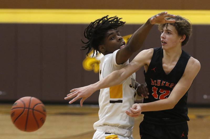 McHenry's Caleb Jett passes the ball as Jacobs' Treval Howard applied pressure during a Fox Valley Conference basketball game Wednesday, Dec. 7, 2022, between Jacobs and McHenry at Jacobs High School in Algonquin.