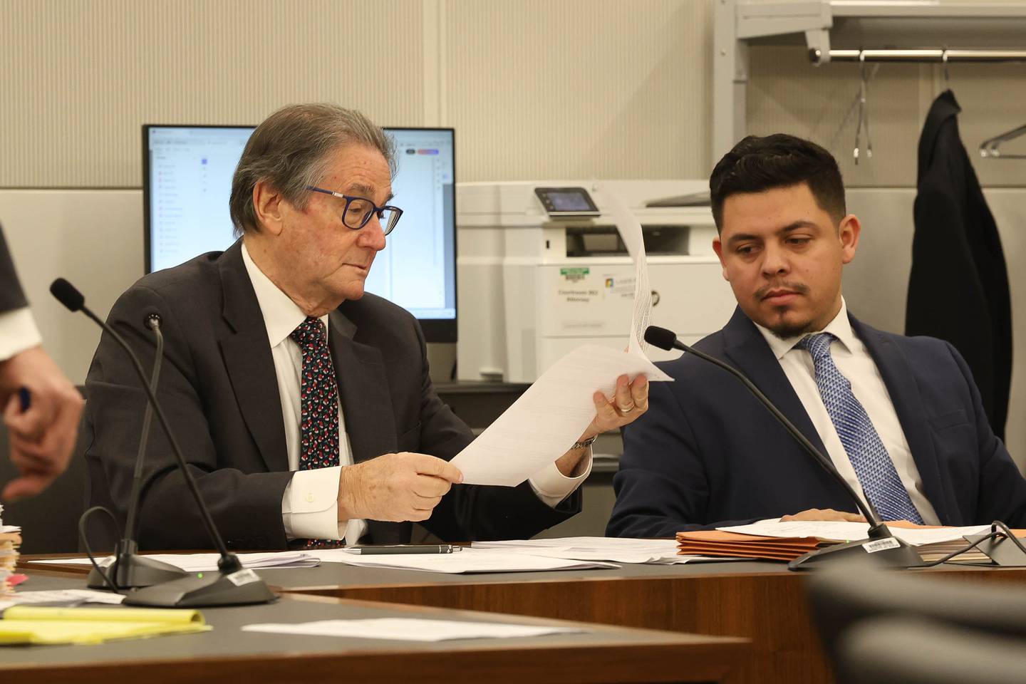 Joliet City Council member Juan Moreno, right, and his attorney Burt Odelson look over a document during a hearing Monday on the case challenging Joliet City Council member Juan Moreno's legitimacy to hold office. Monday, Dec. 8, 2025 at the Will County Courthouse in Joliet.