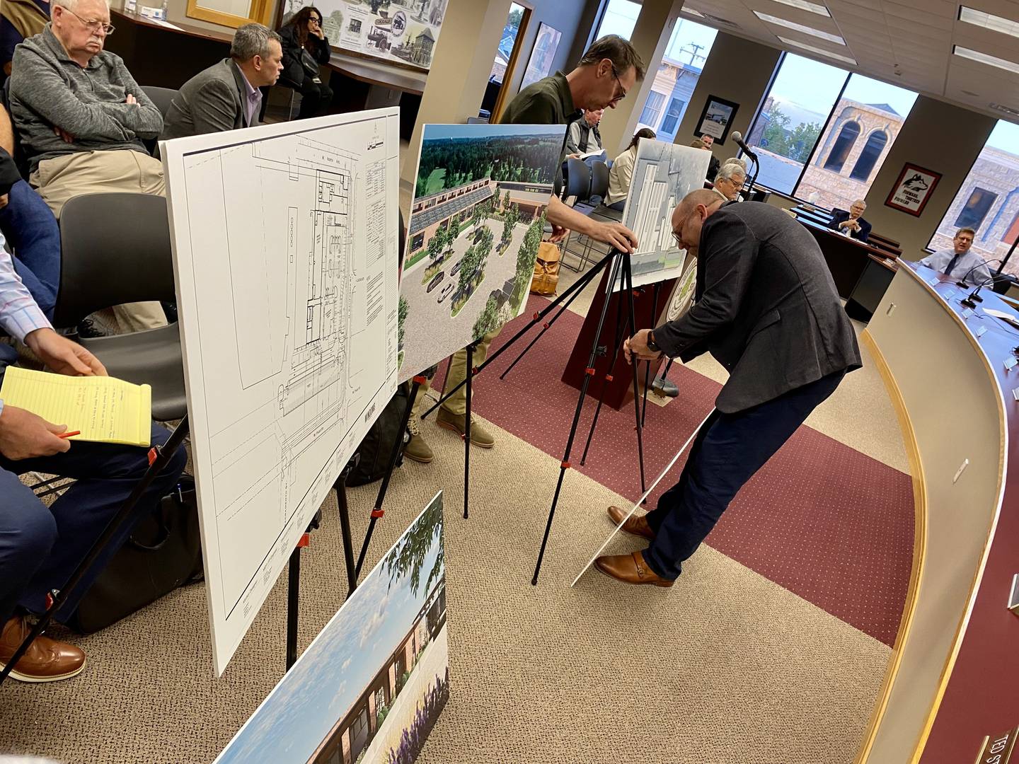 Representatives from Epstein Global architecture firm set up concept plan displays ahead of a presentation during the Sycamore Planning and Zoning Commission meeting Monday, Oct. 9, 2023 at the Sycamore City Center, 308 W. State St. The firm presented plans by Sycamore businessman Chris Mayer for a distillery, restaurant and event space on North California Street.