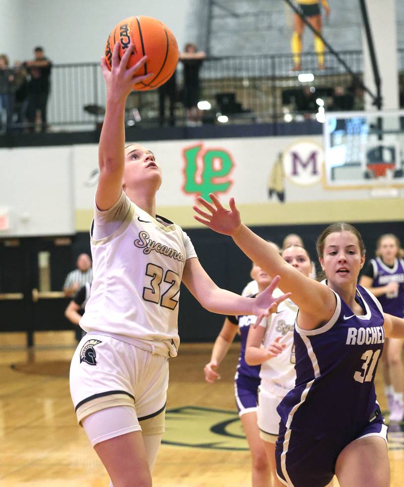 Sycamore's Quinn Carrier gets to the basket ahead of Rochelle's Kendyl Darby during their game Friday, Dec. 6, 2024, at Sycamore High School.