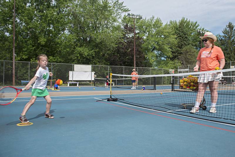 Rachel Catt swings after a ball tossed by instructor Julia Rhodes during the tiny tots event at the Emma Hubbs Tennis Classic Monday, July 25, 2022.