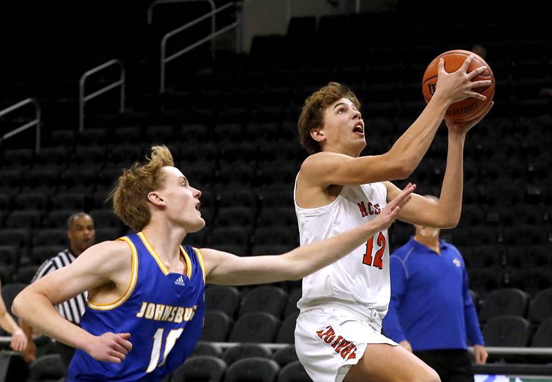 McHenry's Caleb Jett, right, drives to the basket agains Johnsburg's Ben Person during a non-conference basketball game Sunday, Nov. 27, 2022, between Johnsburg and McHenry at Fiserv Forum in Milwaukee.