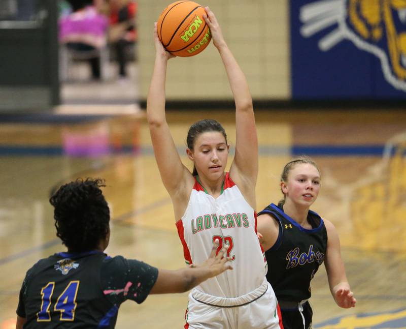 L-P's Brie Ruppert grabs a rebound over Somonauk's Leah Norris and Aubrey Chiavario during the Tim Humes Breakout Tournament on Friday, Nov. 22, 2024 at Somonauk High school.