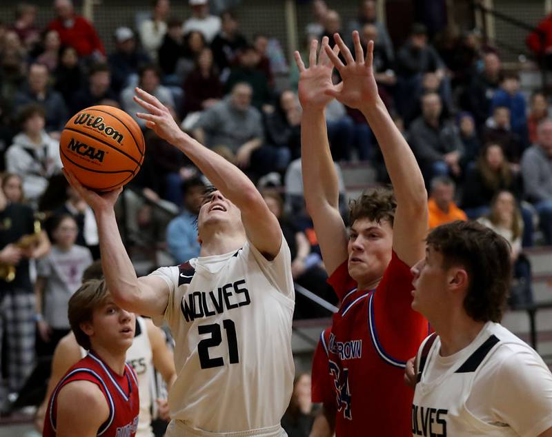 Prairie Ridge's Brendan Beu shoots the ball in front of Dundee-Crown's Hudson Reardon during a Fox Valley Conference boys basketball game on Friday, Jan. 16, 2026, at Prairie Ridge High School in Crystal Lake.