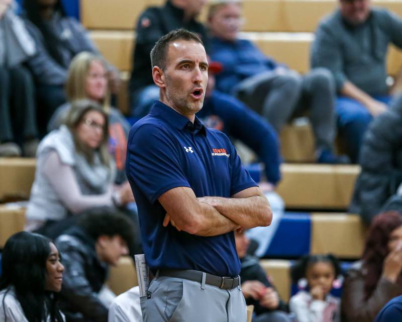 Oswego's head coach Chad Pohlmann yells out plays during their basketball game between Yorkville at Oswego, Tuesday Dec 10, 2024 in Oswego.