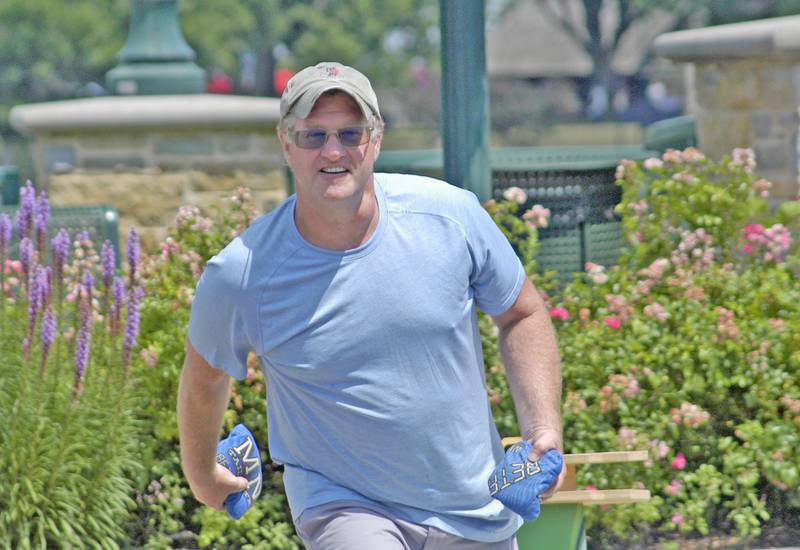 John Fritz of the team "Always A Champ" tosses a bag during the bags tournament