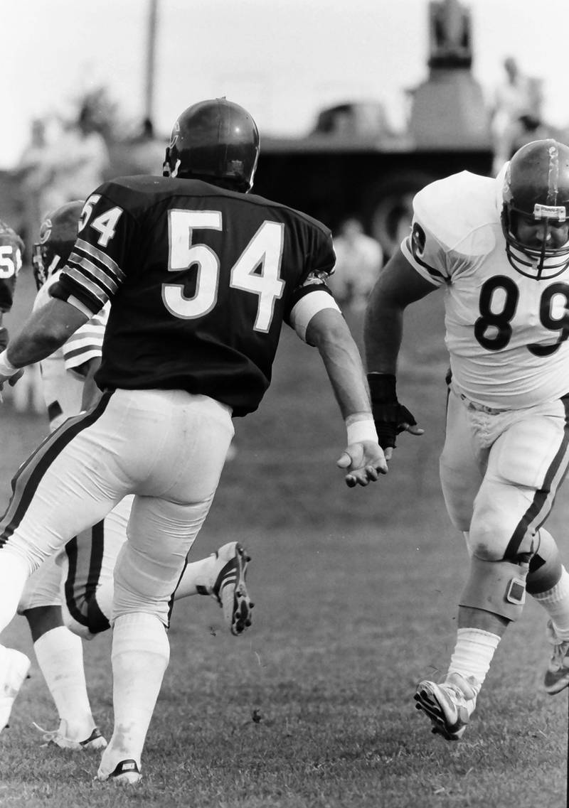 Chicago Bears linebacker Brian Cabral (left) and wide receiver Mitch Krenk practice during training camp on Wednesday, June 12, 1985 in Platteville Wis.