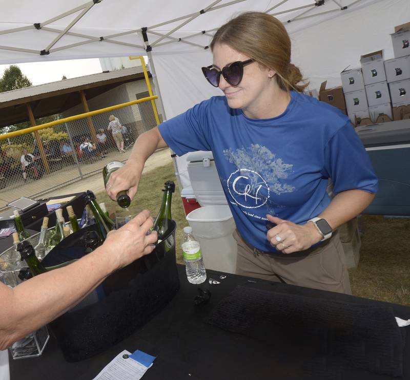 Jen Alteri of August Hill Wine, pour a glass during the Vintage Wine Festival Saturday at Carey Memorial Park in Utica.