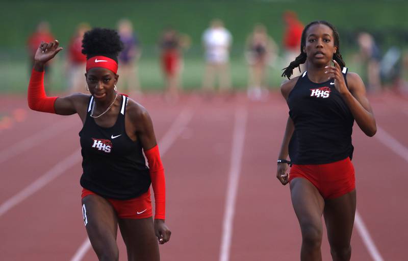 Huntley’s Melissa Aninagyei-Bonsu and Alex Johnson race to the finish line in the 100 meters during the IHSA Class 3A Huntley Girls Track Sectional Wednesday, May 11, 2022, at Huntley High School.
