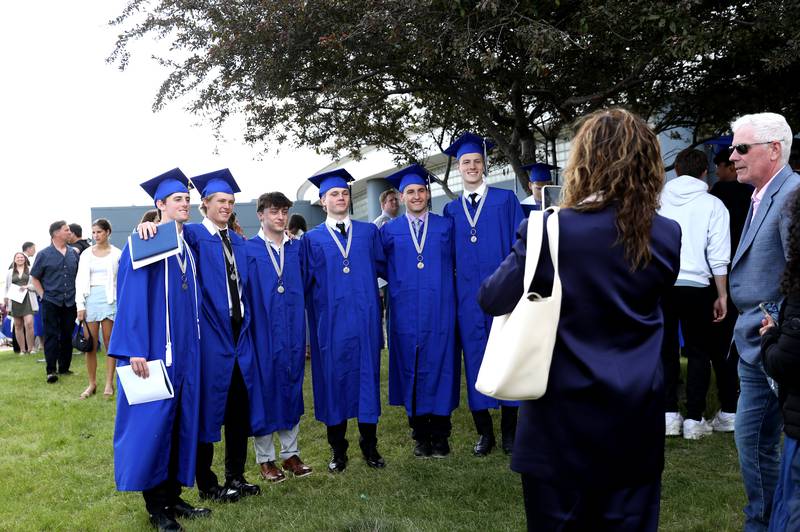 St. Charles North graduates pose for photos following the school’s 2025 commencement ceremony on Thursday, May 22, 2025 at Northern Illinois University in DeKalb.