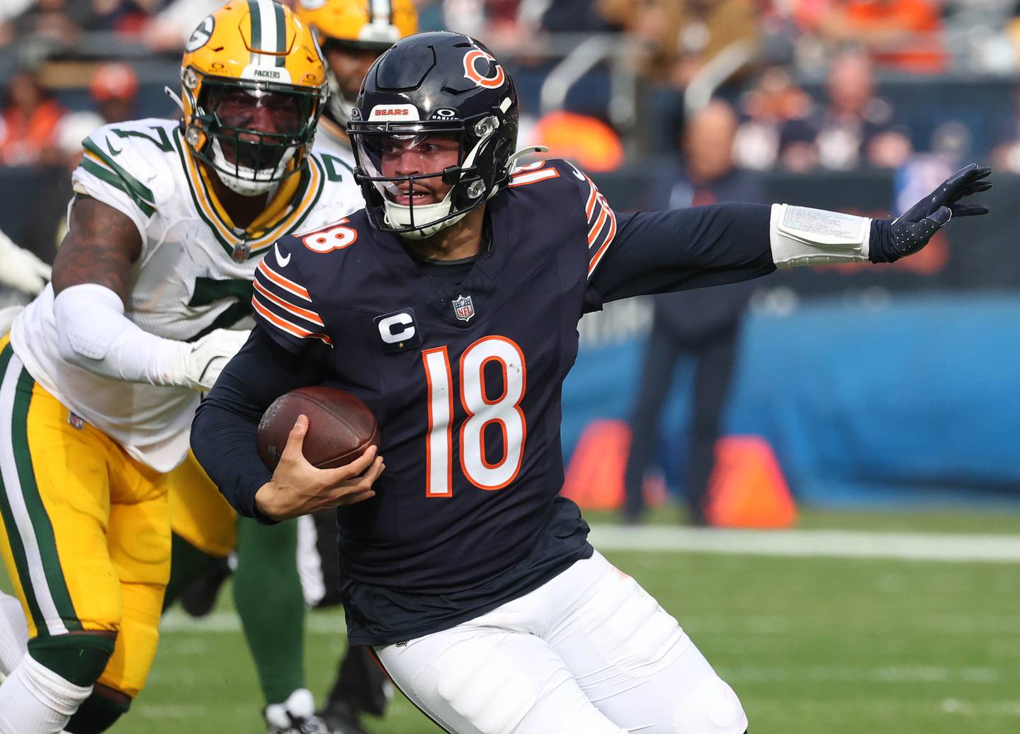 Chicago Bears quarterback Caleb Williams runs ahead of Green Bay Packers linebacker Quay Walker Sunday, Nov. 17, 2024, during their game at Soldier Field in Chicago.