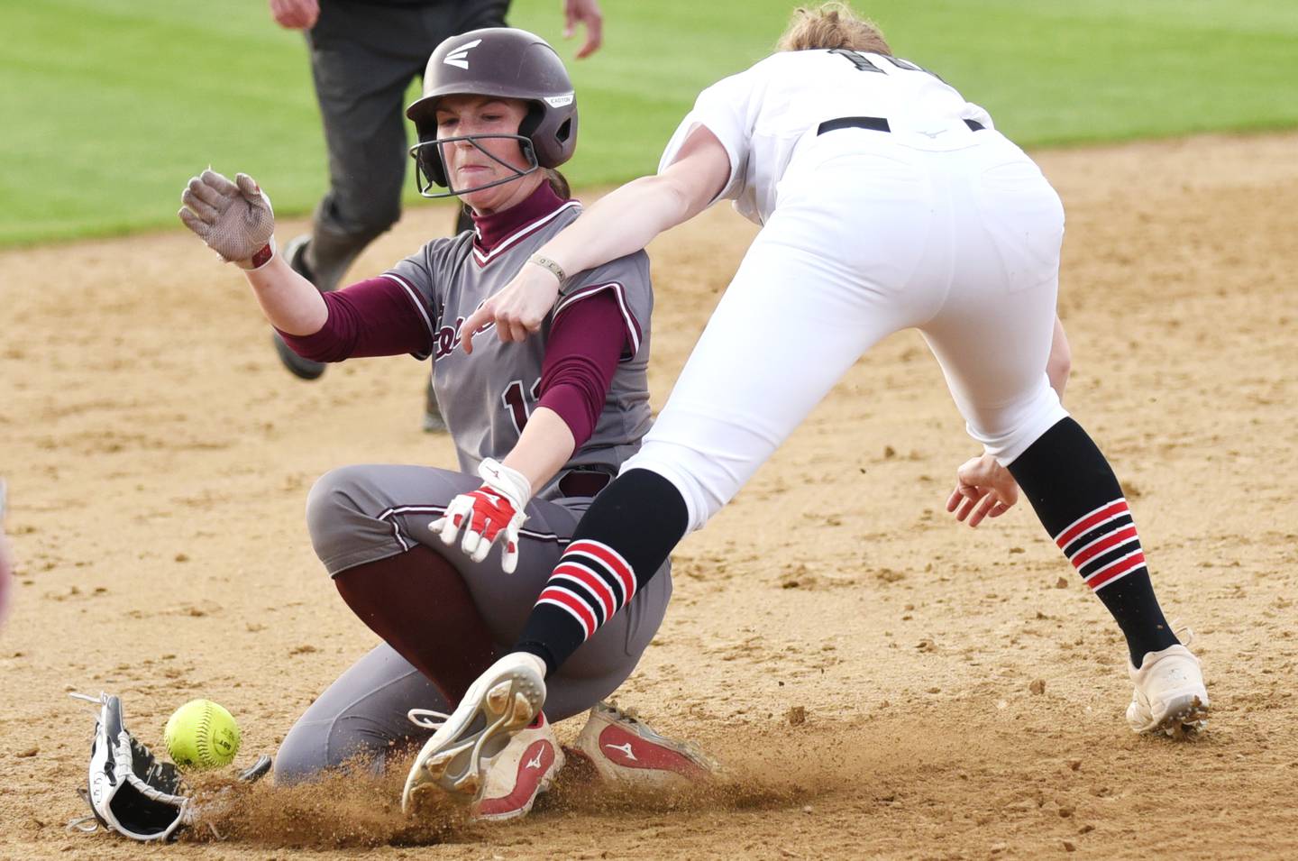 Lockport's Coley Sievers, left, slides through Bradley-Bourbonnais' Abbie Hofbauer and into third base during a game at Bradley-Bourbonnais Tuesday, April 28, 2026.
