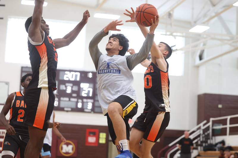 Joliet Central’s Eric Contreras goes up for a shot against DeKalb at the 37th Morris Boys Shootout on Tuesday, June 25, 2024.
