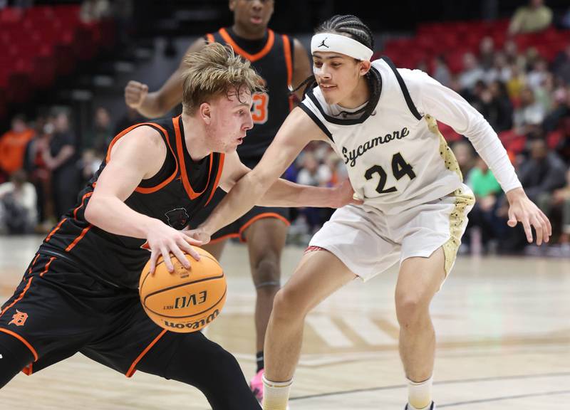 DeKalb's Sean Reynolds works against Sycamore's Unique Shaw during their game Friday, Jan. 31, 2025, in the FNBO Challenge in the Convocation Center at Northern Illinois University in DeKalb.