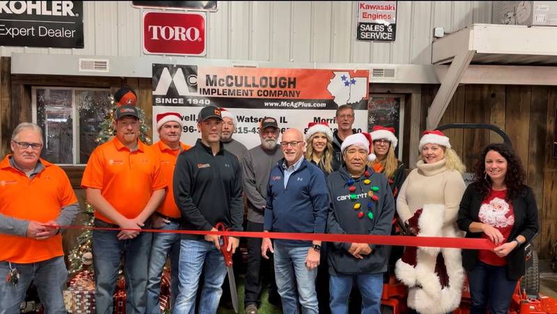 Matt and Steve McCullough (center) cut the ribbon at the Grundy Chamber ribbon cutting held to celebrate McCullough Implement’s holiday open house Dec. 3. The McCullough family purchased Turf Team in Morris earlier this year.