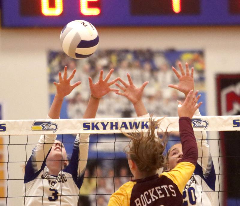 Richmond-Burton’s Reagan Wisniewski, center, battles Johnsburg’s Alexis Sweetwood, left, and Kaia Sasak, right, at the net in varsity girls volleyball at Johnsburg High School in Johnsburg on Thursday, August 25, 2025.