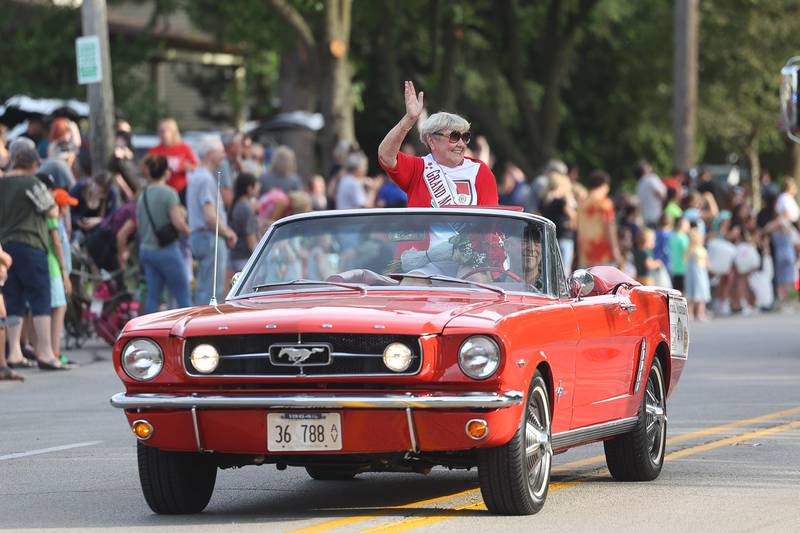 Old Canal Days Parade Grand Marshall waves to the crowds on Friday June 7, 2024 in Lockport.