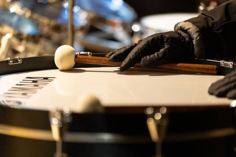 Batavia Community Band percussionist Linda Schielke rests her hand on a drum stick before the band resumed its performance of Christmas carols during the Celebration of Lights at the Batavia Riverwalk on Sunday, Dec. 1, 2024.