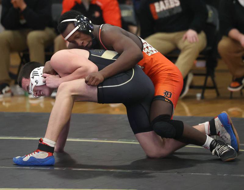 DeKalb’s Malik Warren scores points against Sycamore’s Ian Ruiz during their 175 pound match Friday, Jan. 16, 2026, at Sycamore High School.