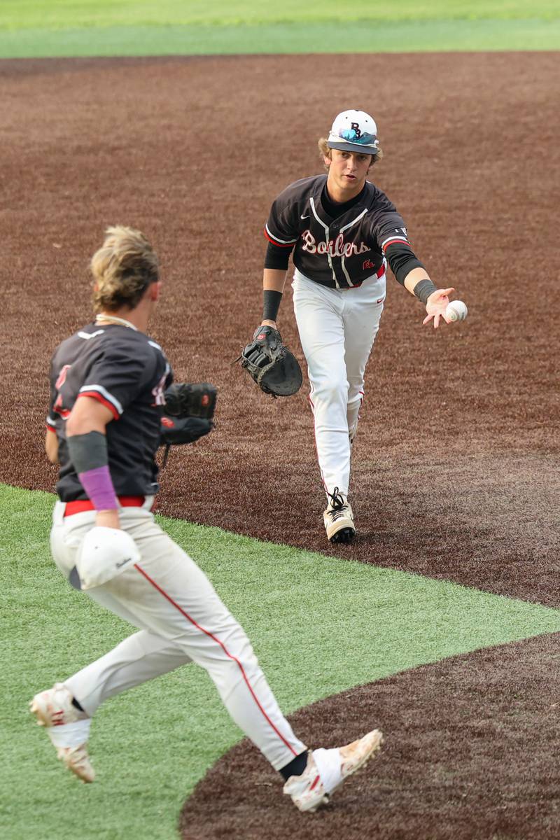 Bradley-Bourbonnais’ Eric Rainbolt tosses to Cody Freitas for the out at first base during the Boilermakers’ 2-0 loss to Normal Community in the IHSA Class 4A Illinois Wesleyan University Sectional semifinal on Thursday, June 5, 2025.