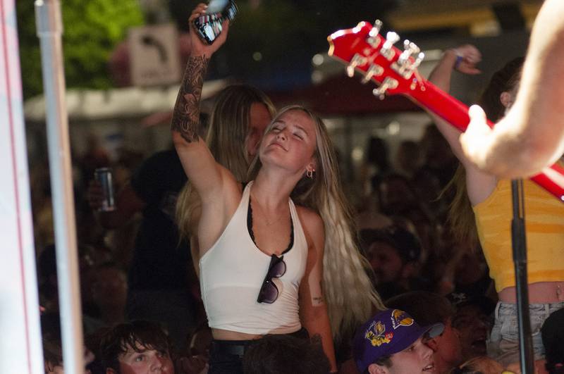 A fan sways and dances to the music of Saturday’s Petunia Fest headliner “Too Fighters” in Dixon.