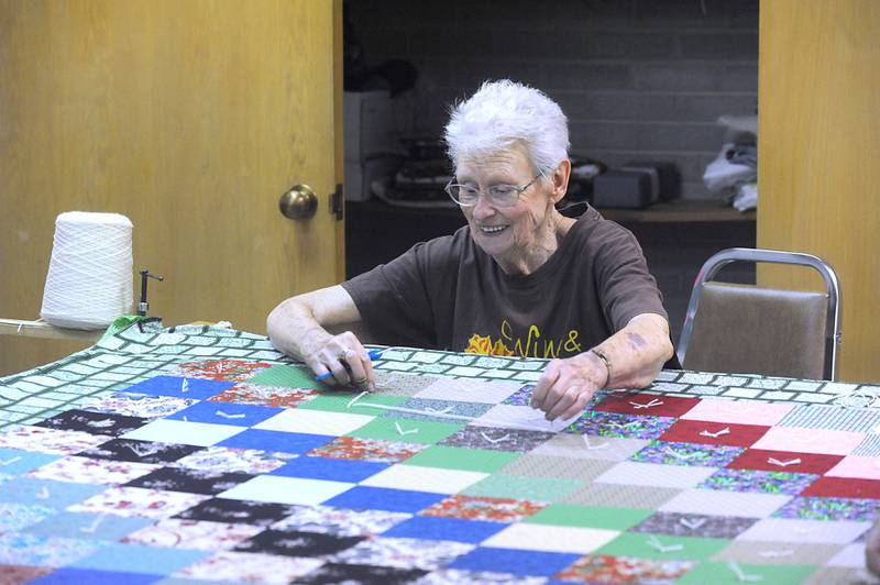 Jean Grandt stitches a quilt Wednesday, May 11, 2022, to send to Lutheran World Relief, in the basement of Zion Evangelical Lutheran Church and School, 4206 W. Elm St. in McHenry. Since January, with the quilters now able to meet in person again, they have made 11 quilts for people in need.